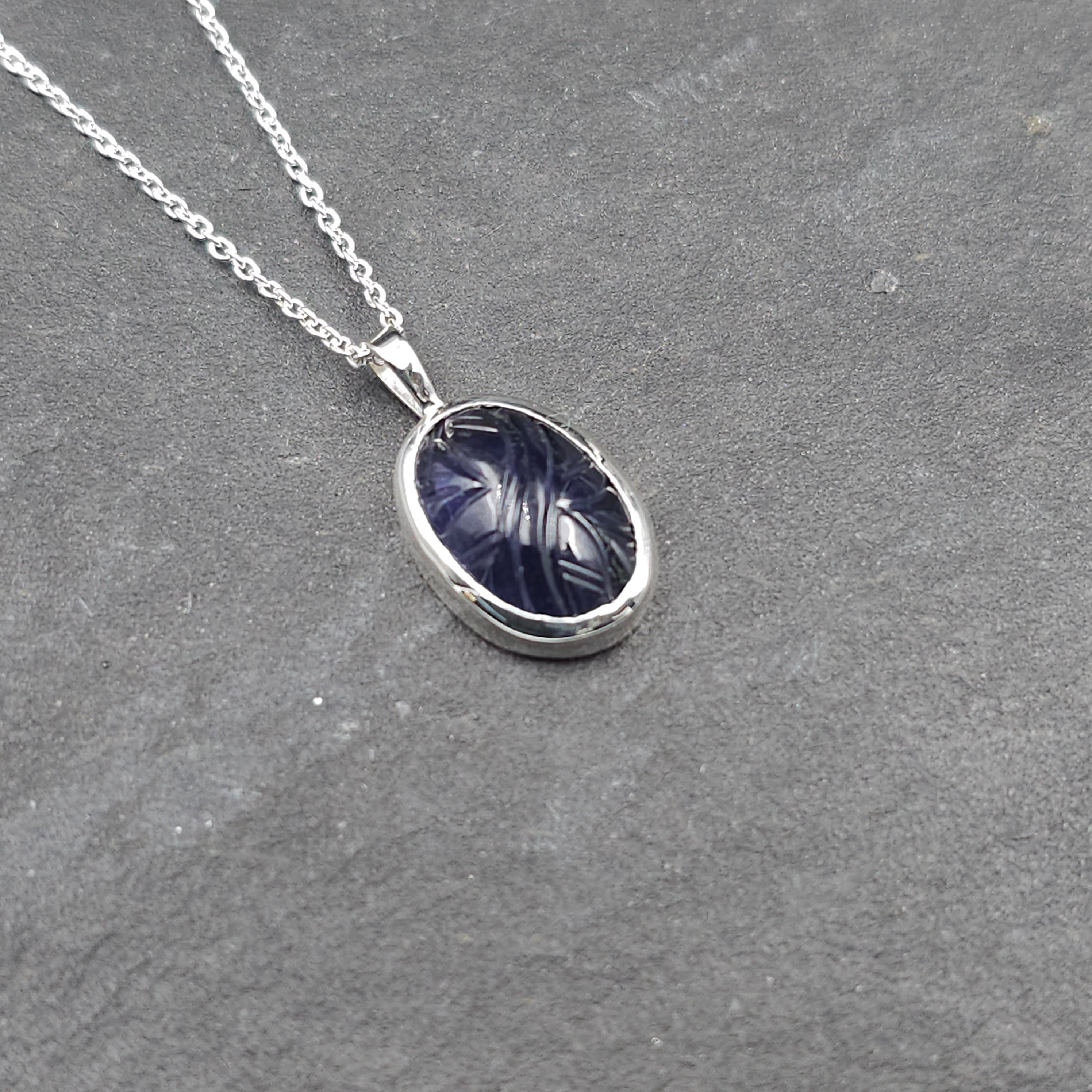 Oval carved dark purple iolite bezel set silver necklace