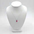 small pinkish red teardrop ruby bead pendant on thin silver cable chain