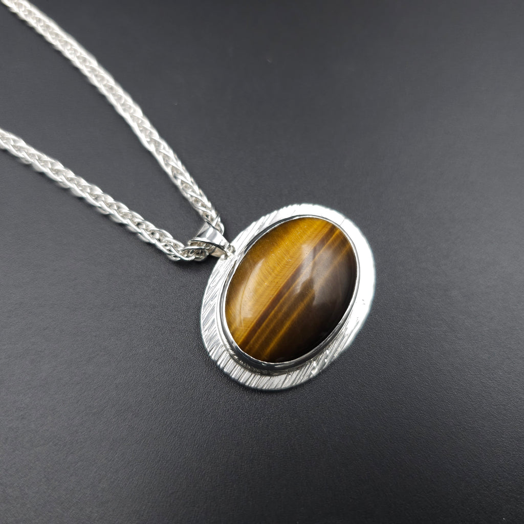 Silver necklace with a horizontal tiger's eye pendant 