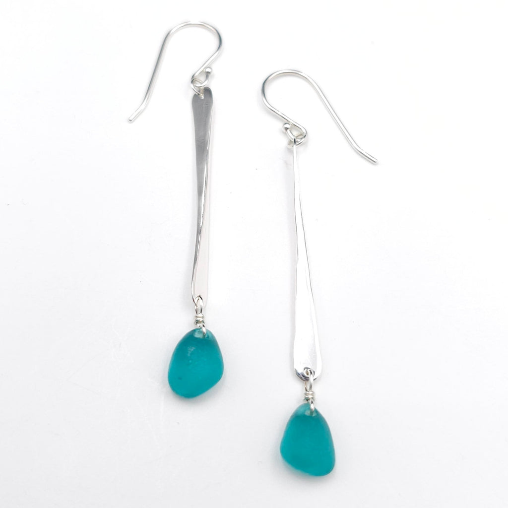 long hammered silver earrings with teal sea glass dangling below