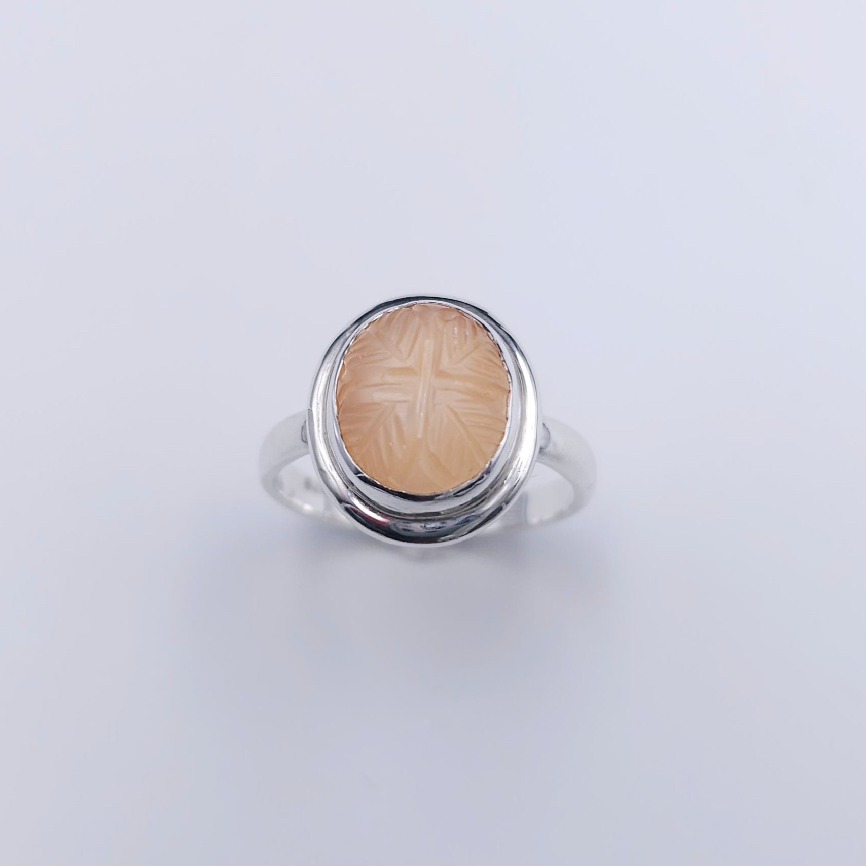 Peach moonstone with leaves carved into stone silver ring