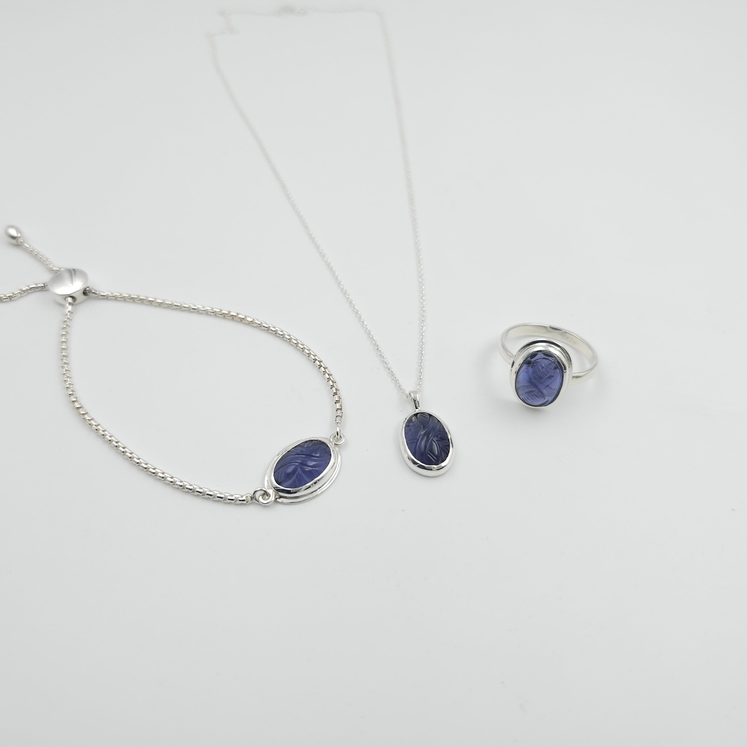 Carved iolite bezel set sterling silver necklace