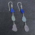 Dark blue, sea foam, and light purple sea glass dangle independently in these sterling silver long dangle earrings.