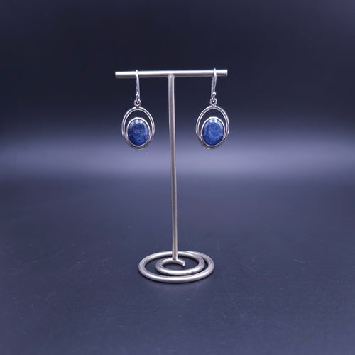 A pair of silver dangle earrings with oval blue kyanite gemstones