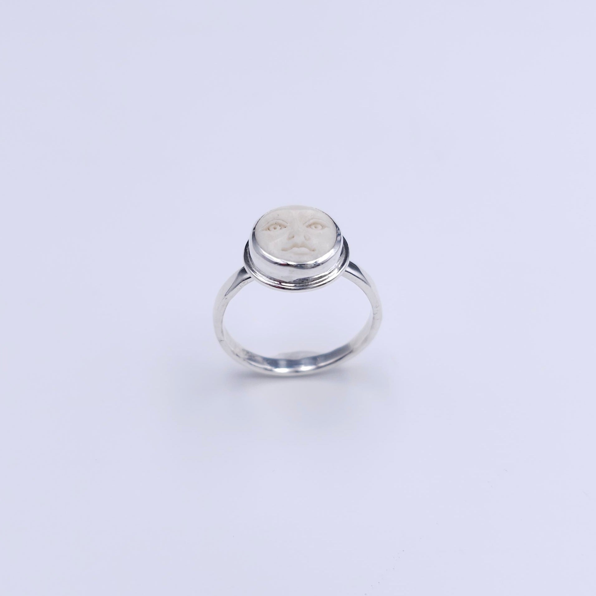 Sterling silver carved face ring