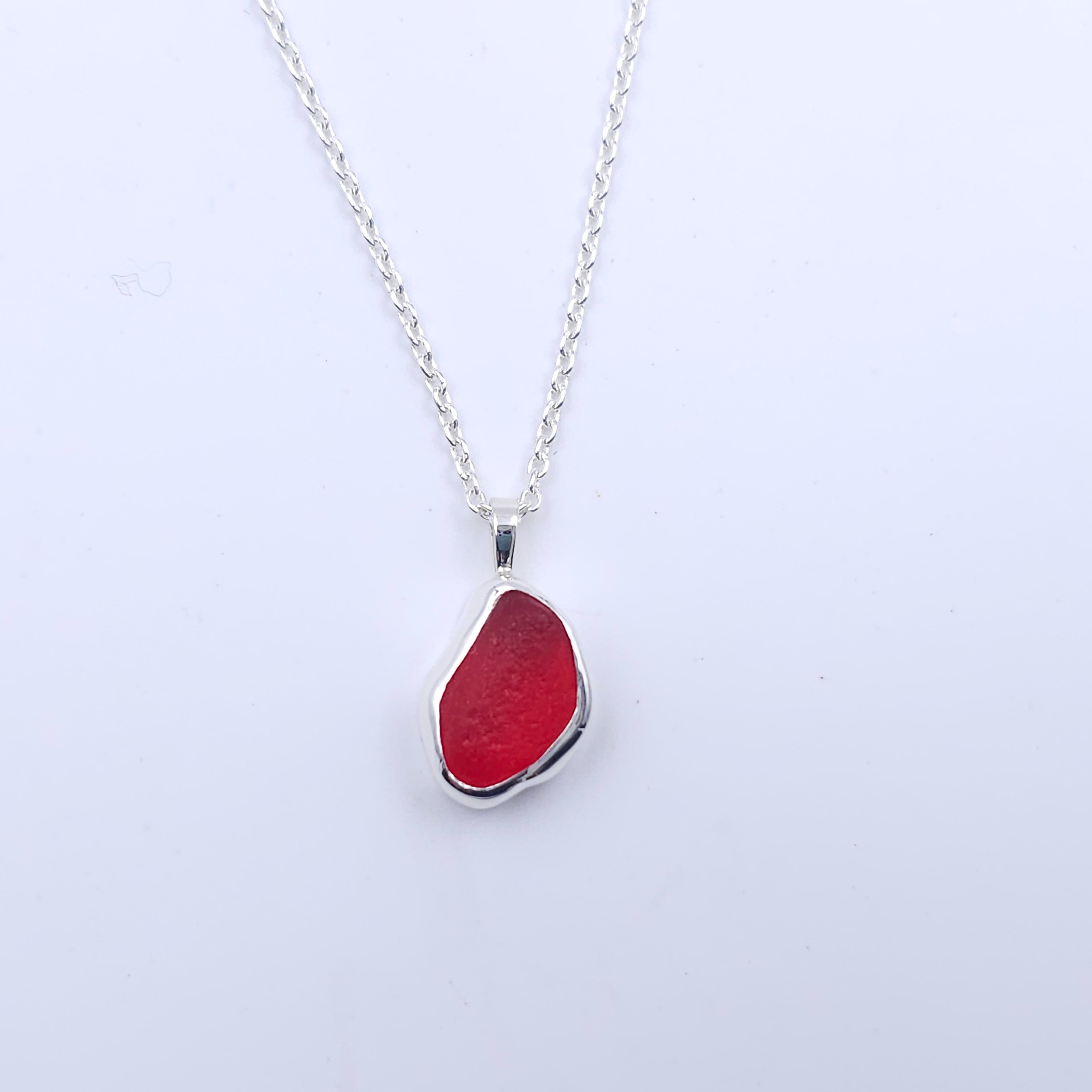 Teardrop freeform shaped red sea glass bezel set silver necklace