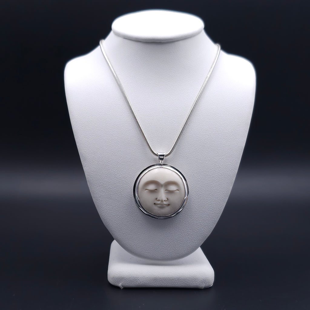 Carved face sterling silver necklace