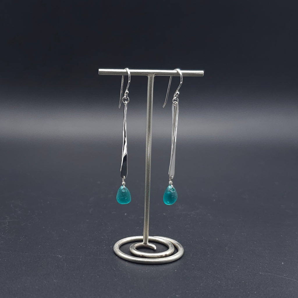 Long hammered dangle earrings with teal sea glass