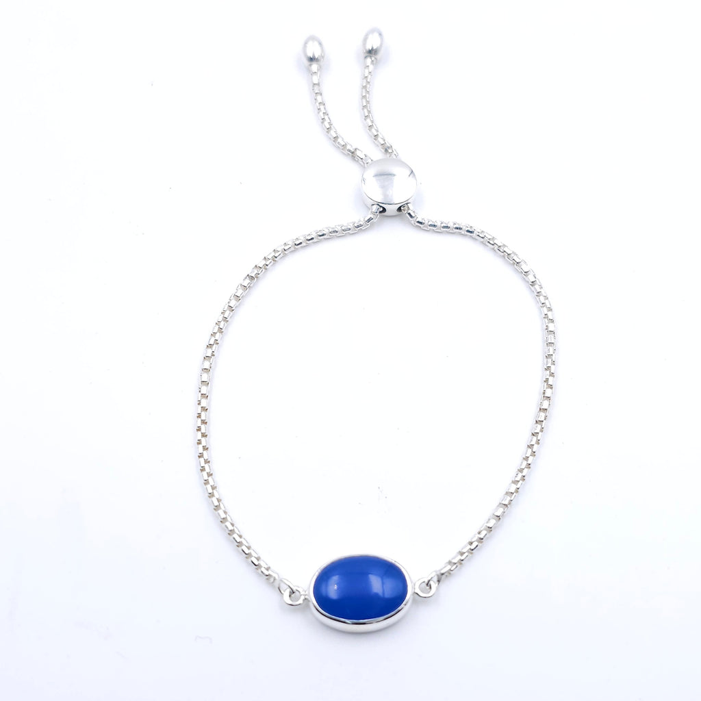 silver adjustable chain bracelet with oval blue bezel set gemstone