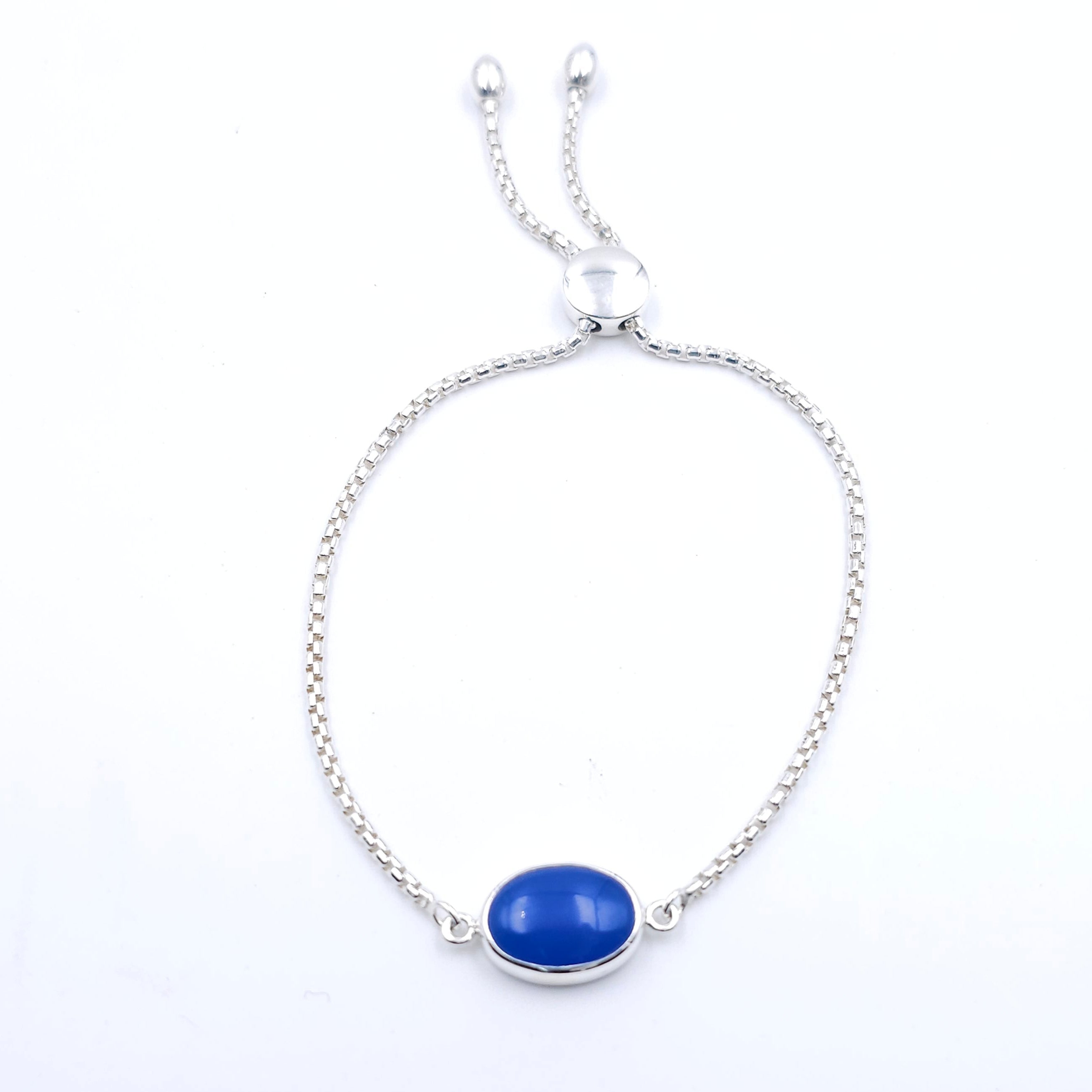 silver adjustable chain bracelet with oval blue bezel set gemstone