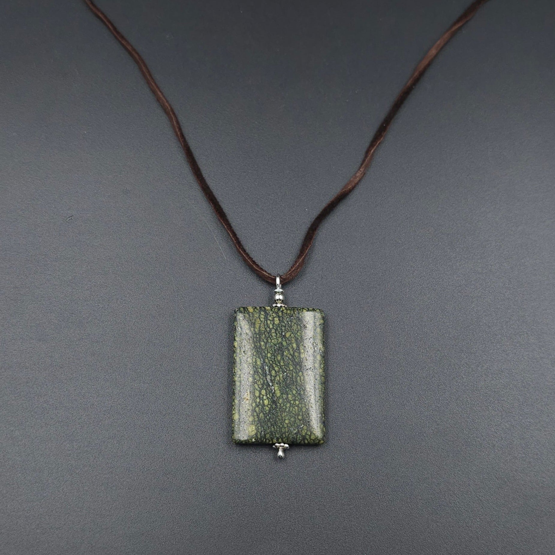 Rectangle spotted green pendant on brown cord