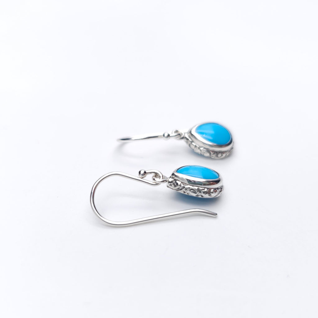 Turquoise teardrop sterling silver dangle earrings with floral border