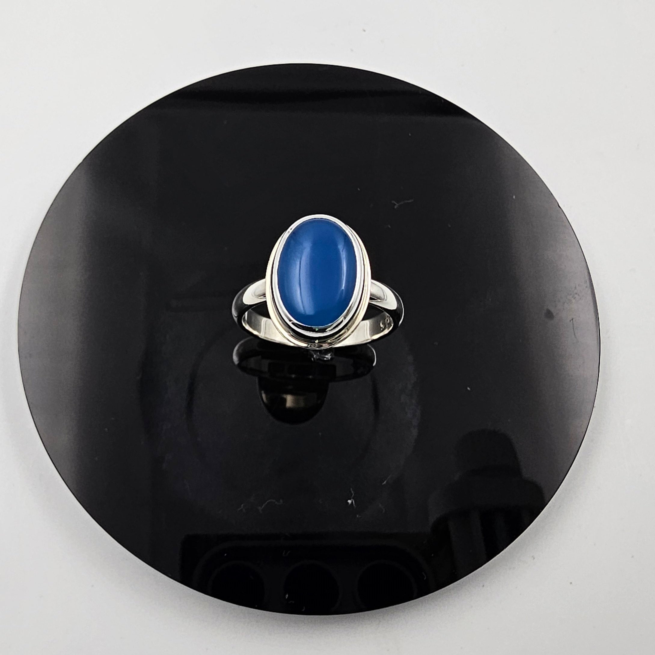 Bezel set oval blue agate gemstone ring in sterling silver