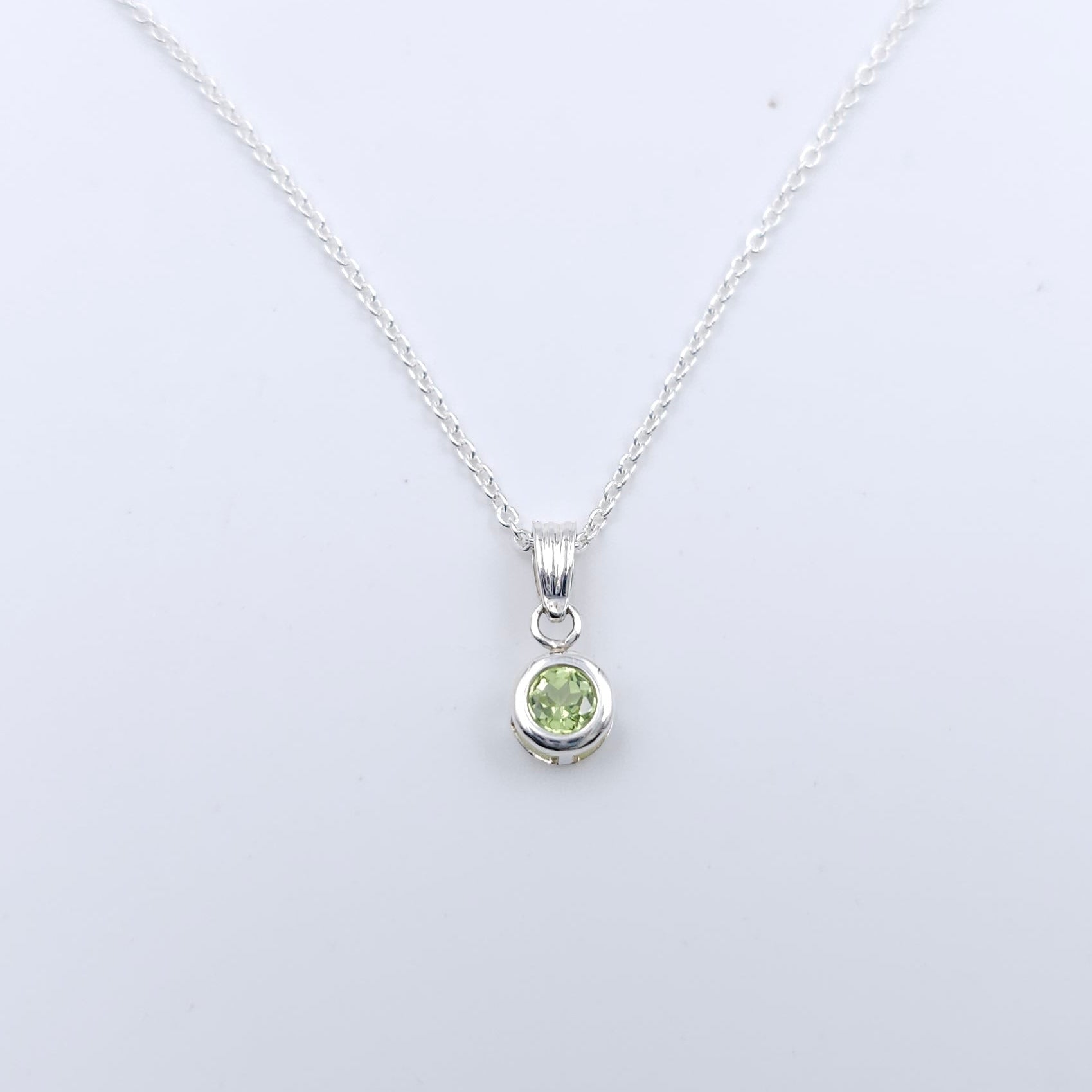 Small round light green faceted bezel set silver necklace