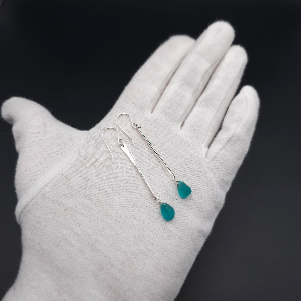 Long hammered dangle earrings with teal sea glass