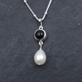 Round bezel set black onyx necklace with teardrop fresh water pearl dangling from bezel