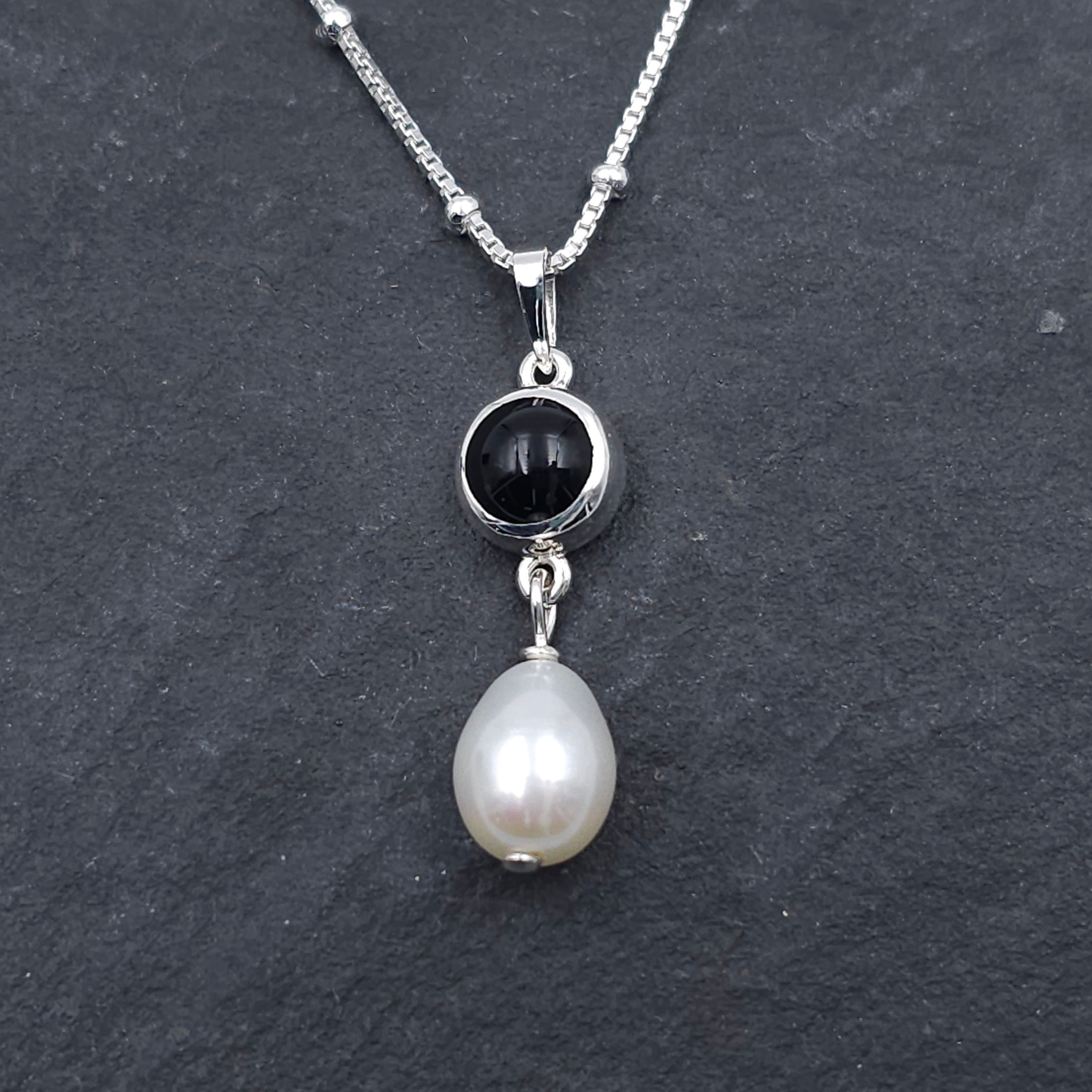 Round bezel set black onyx necklace with teardrop fresh water pearl dangling from bezel