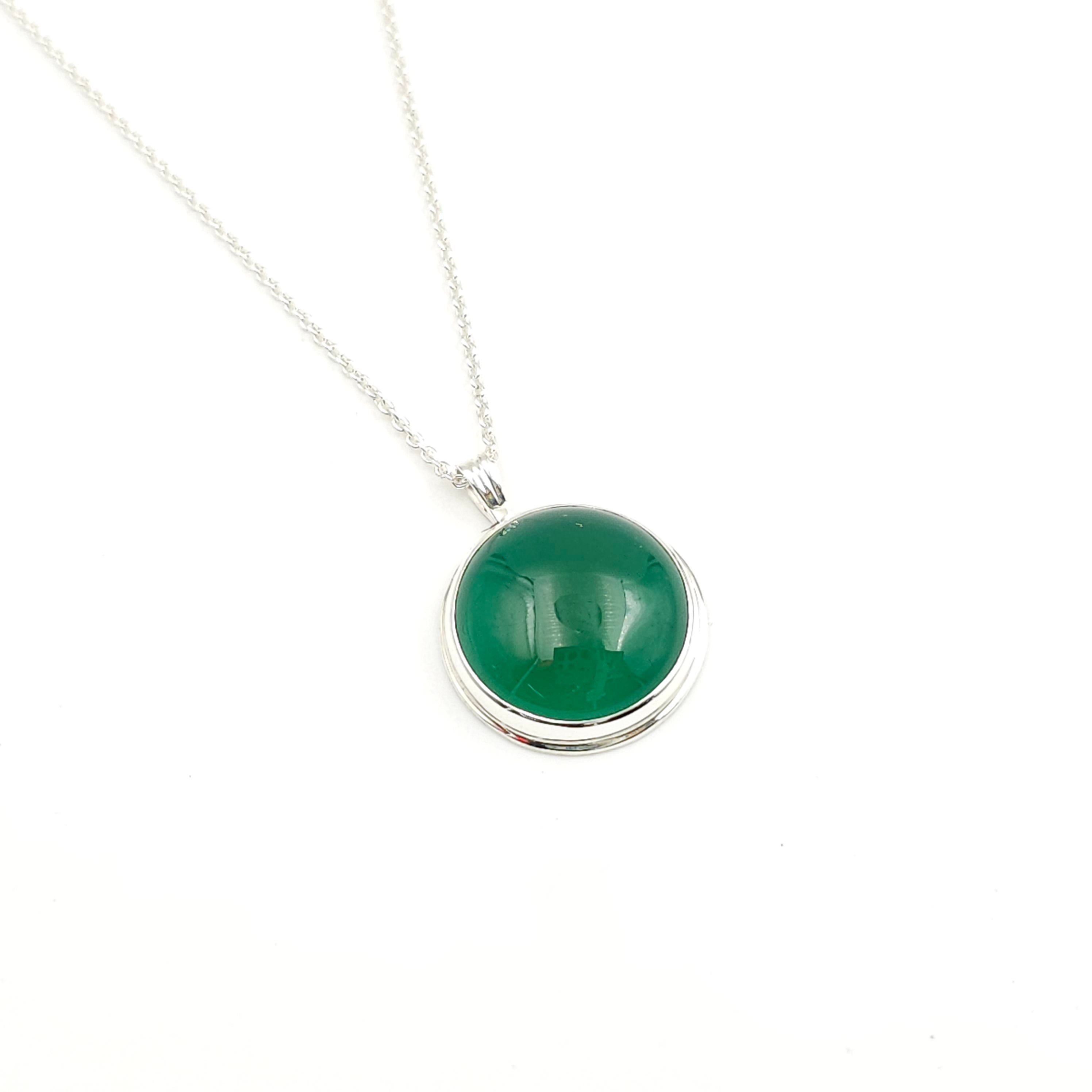 Round green stone necklace in sterling silver bezel with slight silver border around bezel