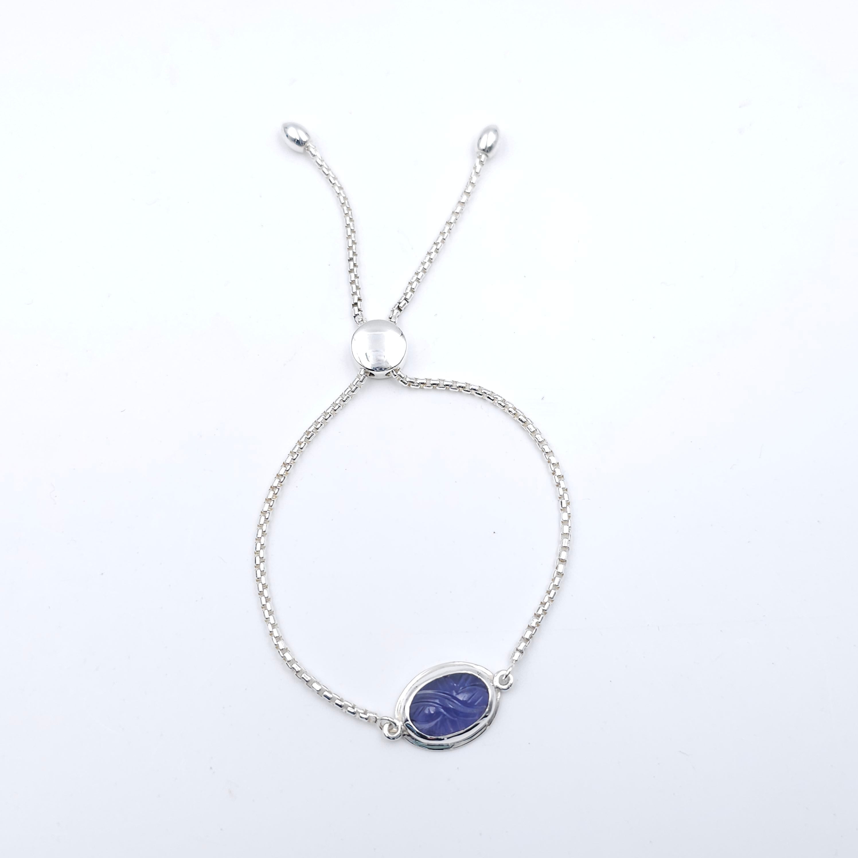 Silver chain adjustable slide bracelet with bezel set carved dark purple iolite gemstone