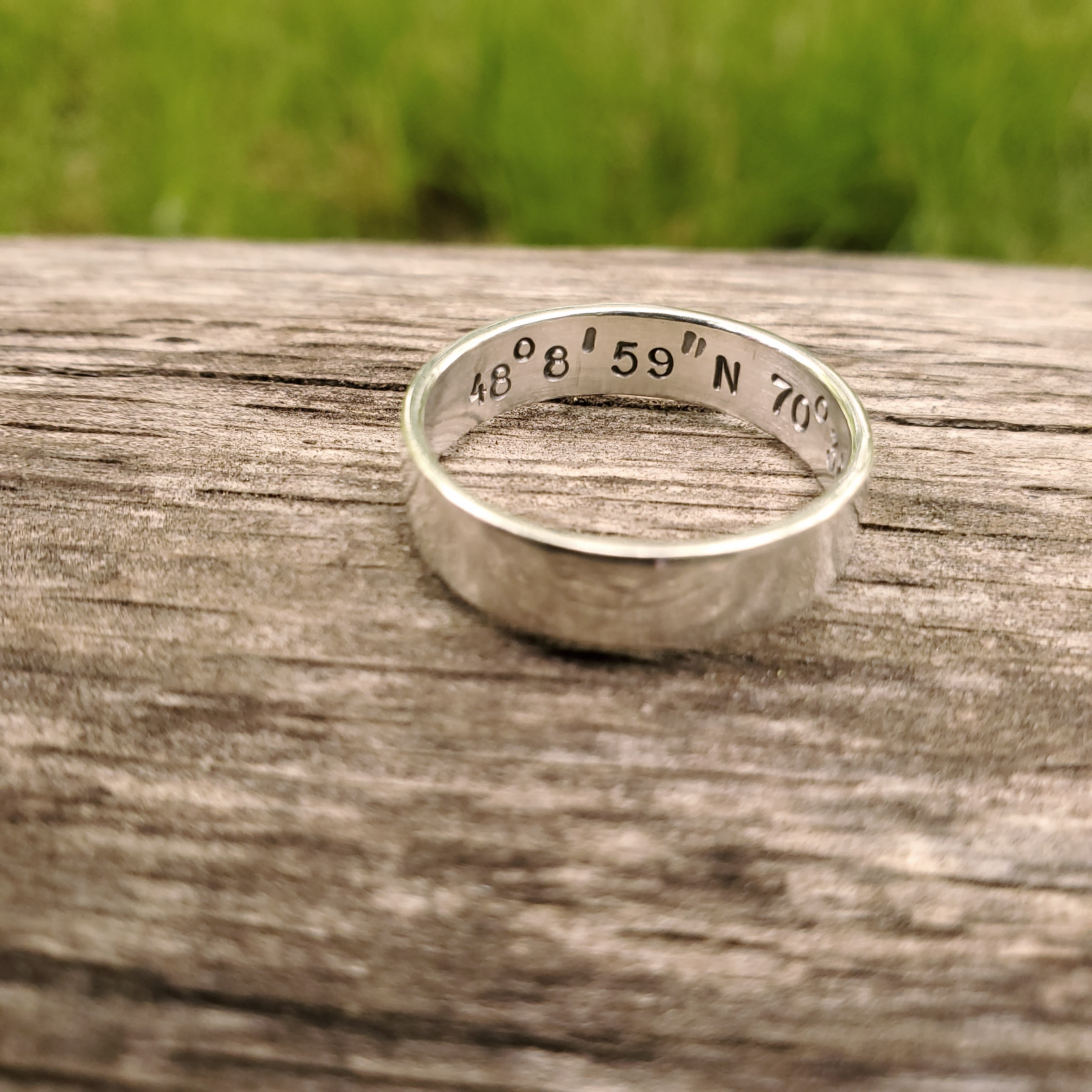Silver ring with coordinates stamped on the inside