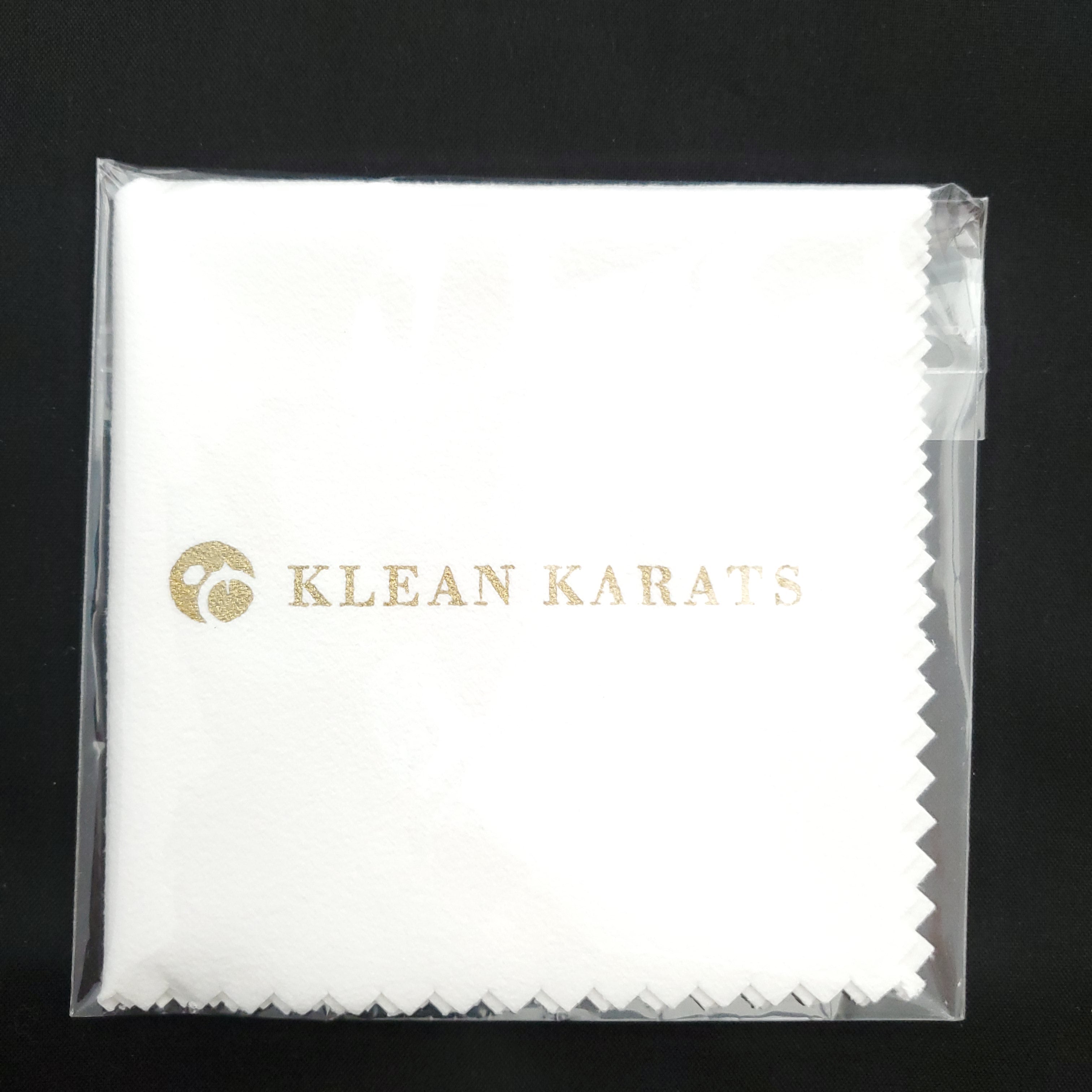 White jewelry polishing cloth folded and wrapped in clear plastic packaging