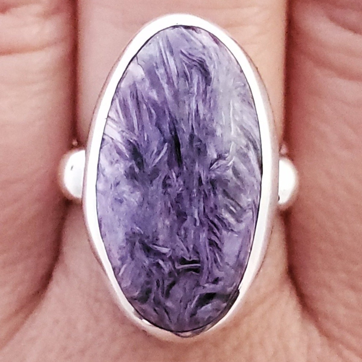 purple charoite ring shown on real hand.