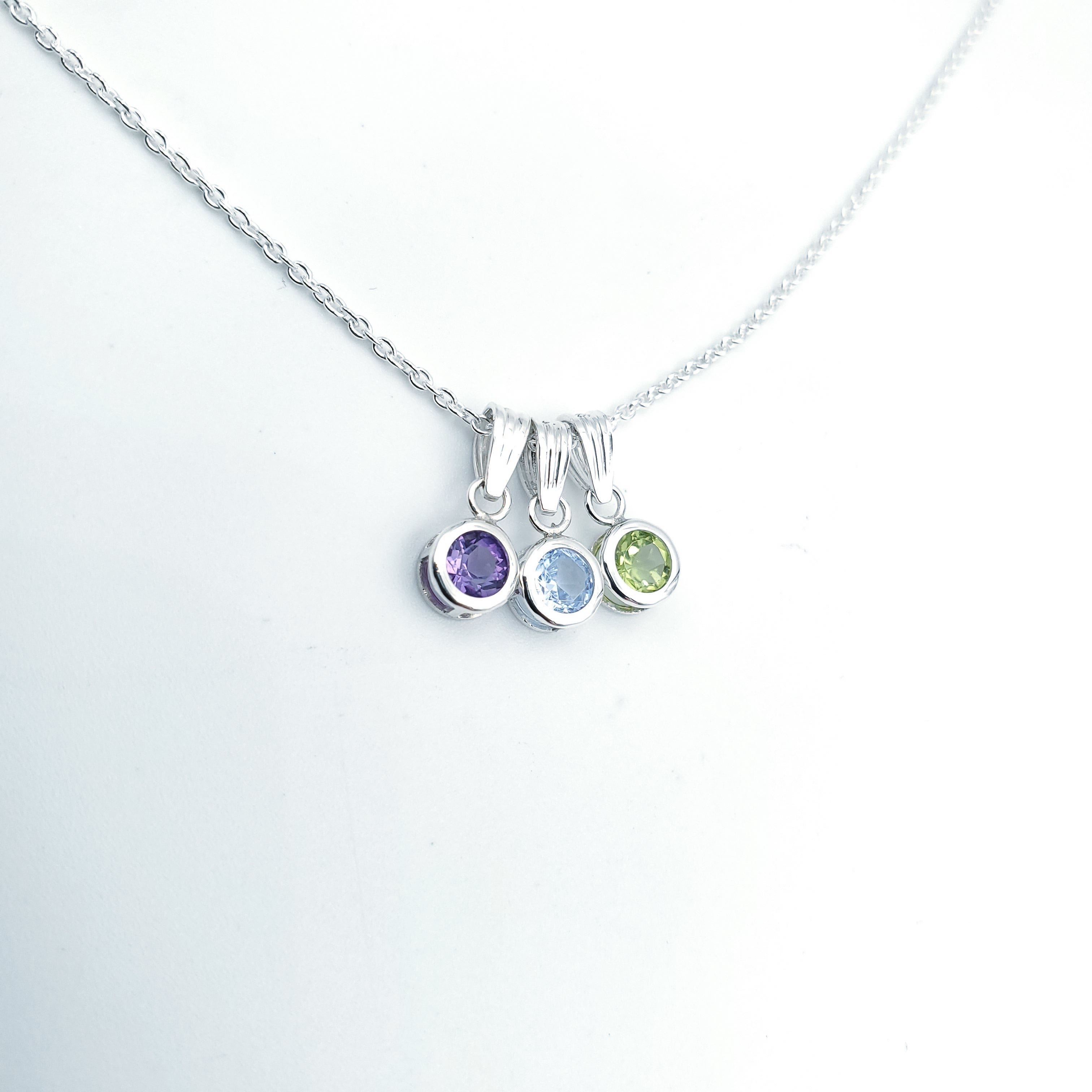 Necklace with three birthstone pendants: February, March, August 