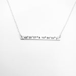 Silver bar necklace with coordinates stamped across bar