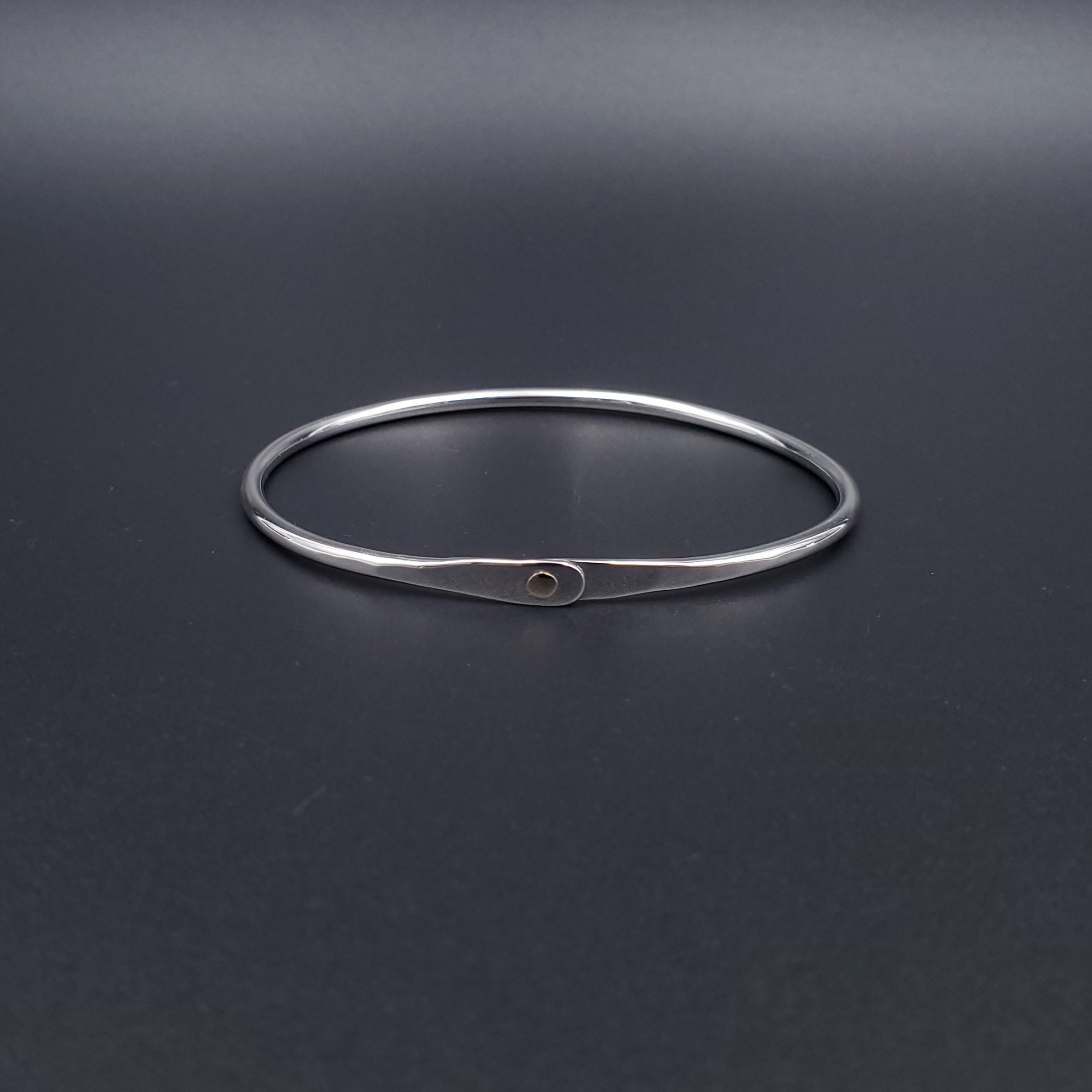 Sterling silver oval bangle bracelet with 14k gold accent