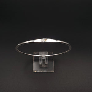 Silver hammered oval bangle with gold rivet