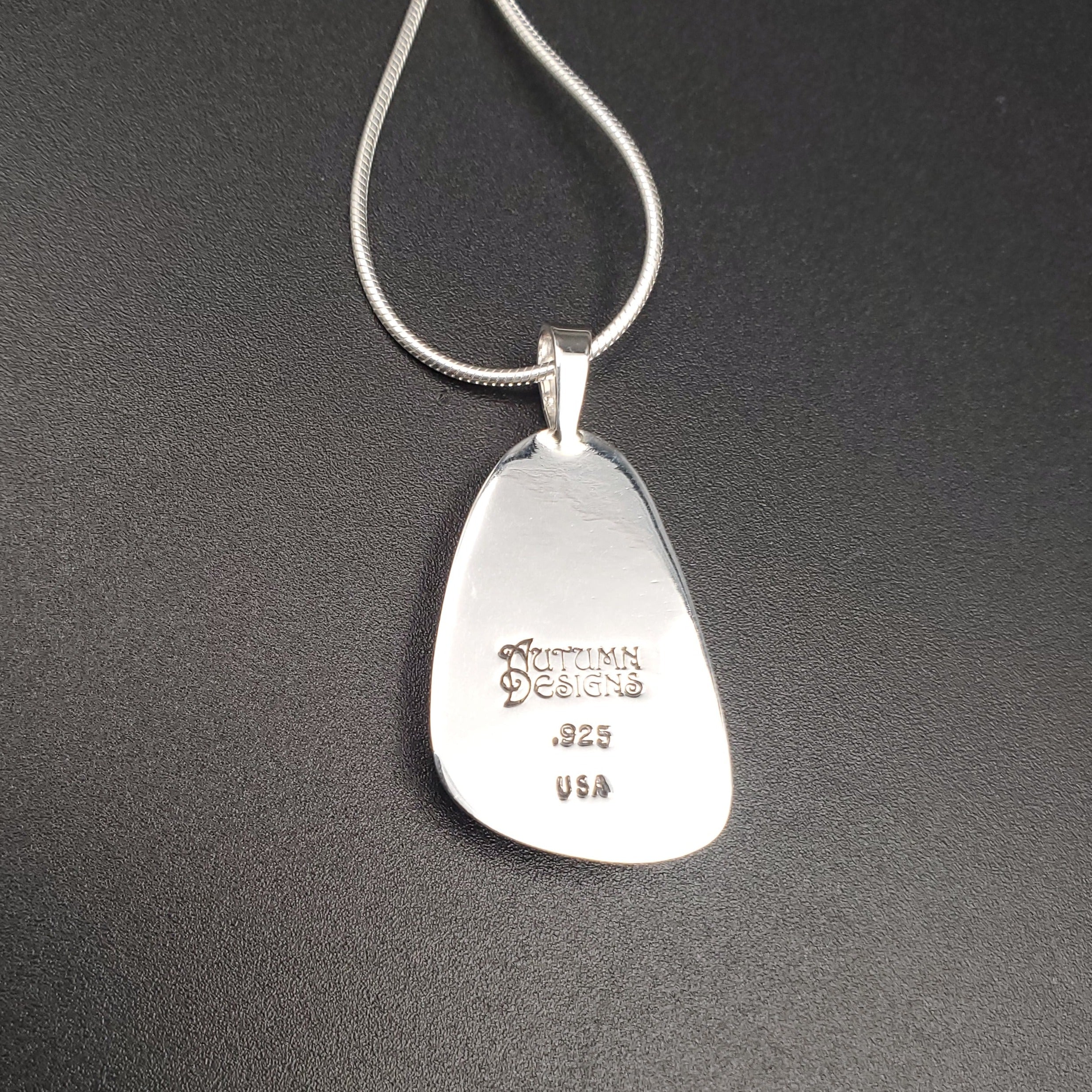 Back of silver necklace showing Autumn Designs stamp, .925, and USA