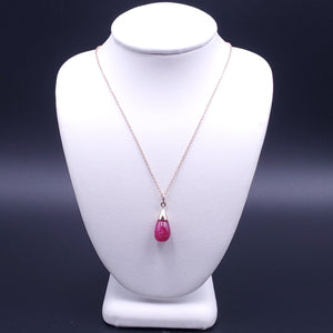 Pinkish red teardrop ruby necklace in 14k gold cone setting