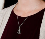 Christmas tree necklace shown on model