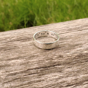 Silver ring with coordinates stamped on the inside