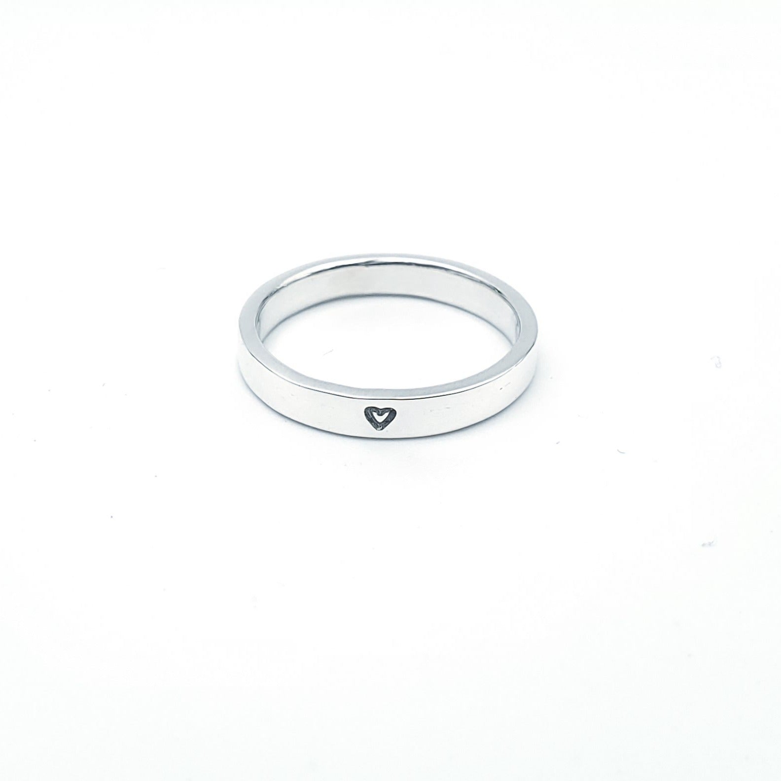 Silver band with small heart stamped into silver